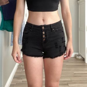 Low waisted black shorts stretchy material, slightly distressed